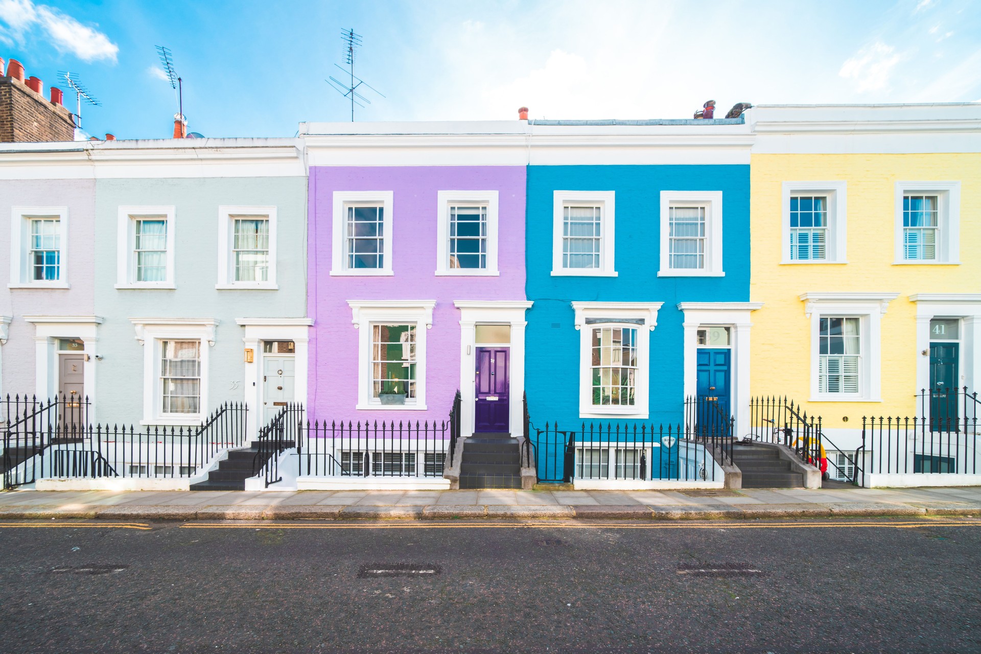 Colorful English houses facades, pastel pale colors in London